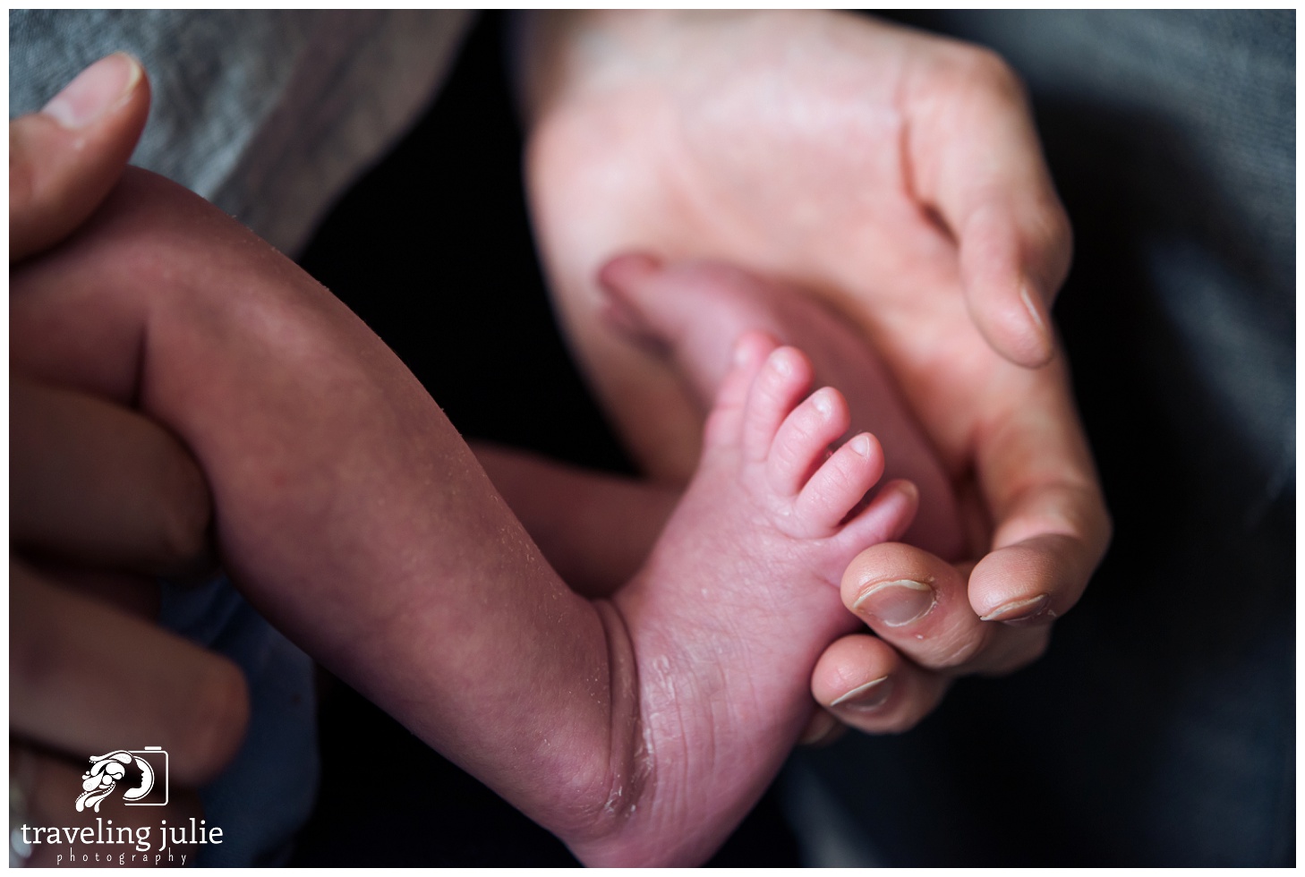 tiny newborn feet and parent's hand