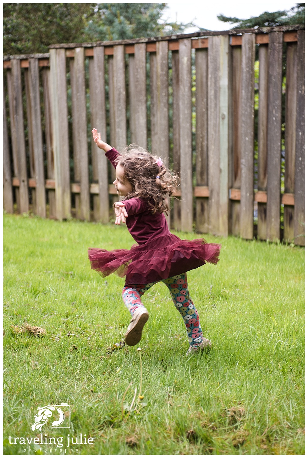 Little girl twirling in yard